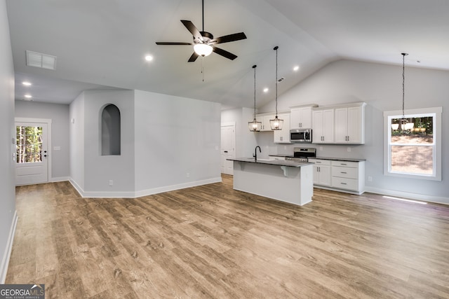 TRACT3 Georgia Highway 100, Buchanan, GA 30113 - kitchen with stainless steel appliances, open floor plan, a kitchen bar, light wood finished floors, and white cabinetry