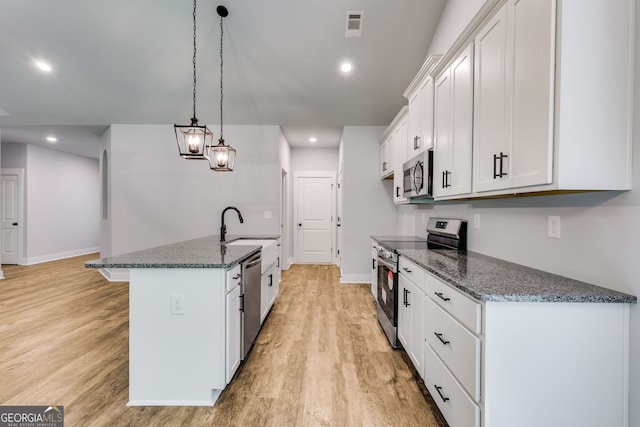 TRACT3 Georgia Highway 100, Buchanan, GA 30113 - kitchen with stainless steel appliances, light wood-style floors, white cabinets, dark stone countertops, and recessed lighting