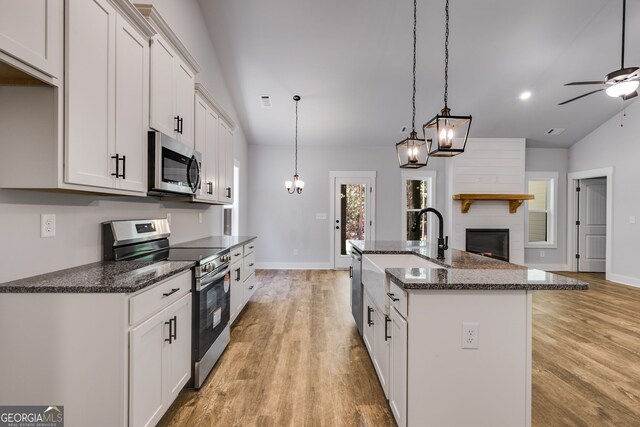 TRACT3 Georgia Highway 100, Buchanan, GA 30113 - kitchen featuring stainless steel appliances, open floor plan, light wood-style floors, an island with sink, and a ceiling fan