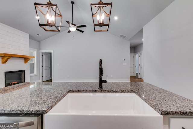 TRACT3 Georgia Highway 100, Buchanan, GA 30113 - kitchen featuring a chandelier, ceiling fan, vaulted ceiling, a fireplace, and stone countertops