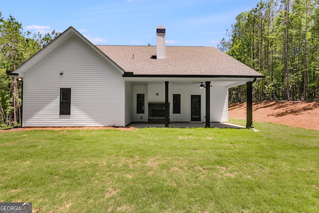 TRACT3 Georgia Highway 100, Buchanan, GA 30113 - rear view of house featuring a patio area, a yard, a chimney, and a shingled roof