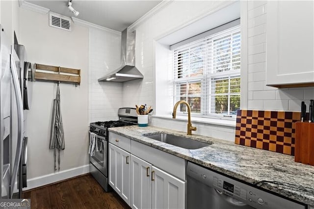 802 Frederica St NE Unit 5, Atlanta, GA 30306 - kitchen featuring appliances with stainless steel finishes, a sink, wall chimney range hood, backsplash, and dark wood-style flooring