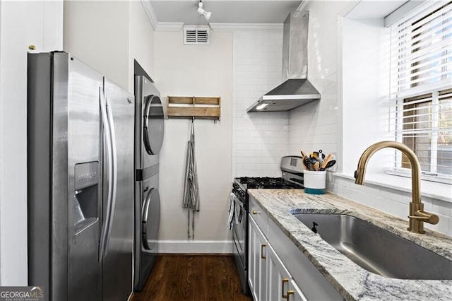 802 Frederica St NE Unit 5, Atlanta, GA 30306 - kitchen featuring stainless steel appliances, a sink, wall chimney exhaust hood, estacked washer and dryer, and crown molding