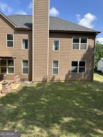 121 Fountain Oak, Villa Rica, GA 30180 - back of house featuring a chimney and a yard
