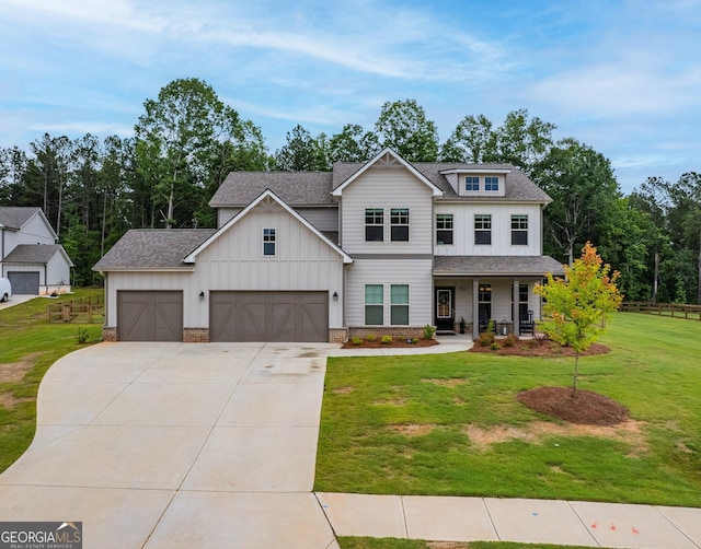 2884 Porches Ln, Dacula, GA 30019 - view of front of house with board and batten siding, driveway, a front lawn, a shingled roof, and a porch