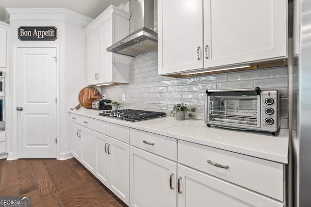 2884 Porches Ln, Dacula, GA 30019 - kitchen featuring wall chimney exhaust hood, stainless steel appliances, white cabinets, dark wood-style floors, and backsplash