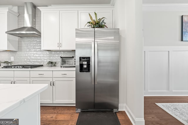 2884 Porches Ln, Dacula, GA 30019 - kitchen featuring appliances with stainless steel finishes, wall chimney exhaust hood, backsplash, white cabinetry, and crown molding