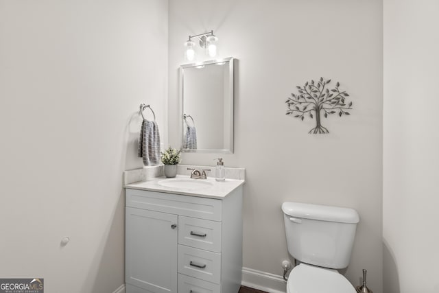 2884 Porches Ln, Dacula, GA 30019 - half bath with vanity, toilet, and baseboards