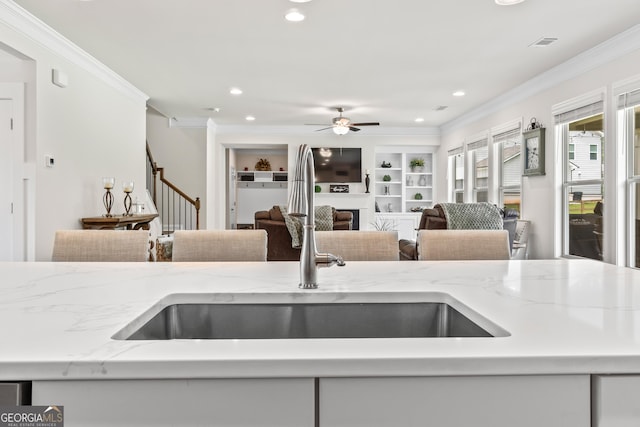2884 Porches Ln, Dacula, GA 30019 - kitchen with a sink, crown molding, a fireplace, recessed lighting, and a ceiling fan