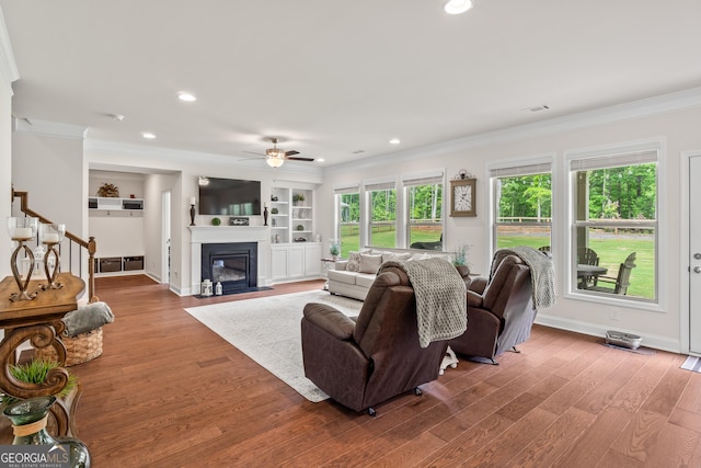 2884 Porches Ln, Dacula, GA 30019 - living area featuring crown molding, a ceiling fan, wood finished floors, stairway, and recessed lighting