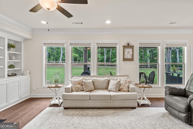 2884 Porches Ln, Dacula, GA 30019 - living room with ornamental molding, a ceiling fan, wood finished floors, and healthy amount of natural light