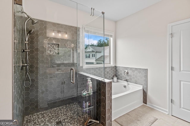 2884 Porches Ln, Dacula, GA 30019 - bathroom with a shower stall, a garden tub, tile patterned floors, and baseboards