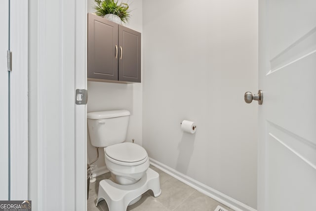 2884 Porches Ln, Dacula, GA 30019 - bathroom featuring toilet, baseboards, and tile patterned flooring