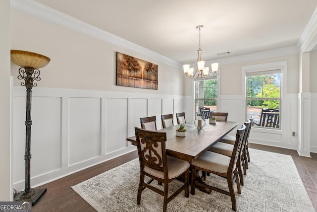 2884 Porches Ln, Dacula, GA 30019 - dining room with a decorative wall, crown molding, a chandelier, dark wood-style flooring, and a wainscoted wall