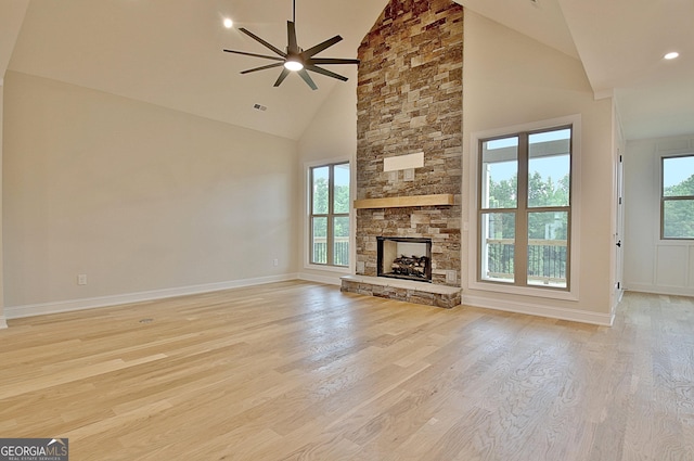 375 Werner Way, Senoia, GA 30276 - unfurnished living room featuring light wood-type flooring, a ceiling fan, high vaulted ceiling, a stone fireplace, and recessed lighting