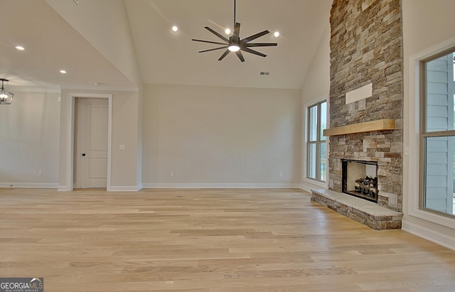 375 Werner Way, Senoia, GA 30276 - unfurnished living room with ceiling fan, a stone fireplace, light wood finished floors, high vaulted ceiling, and recessed lighting