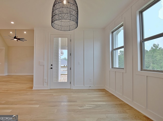 375 Werner Way, Senoia, GA 30276 - unfurnished dining area featuring light wood-type flooring, recessed lighting, a chandelier, a decorative wall, and a ceiling fan