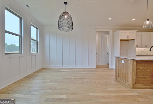 375 Werner Way, Senoia, GA 30276 - unfurnished dining area featuring a decorative wall, light wood-style floors, and recessed lighting