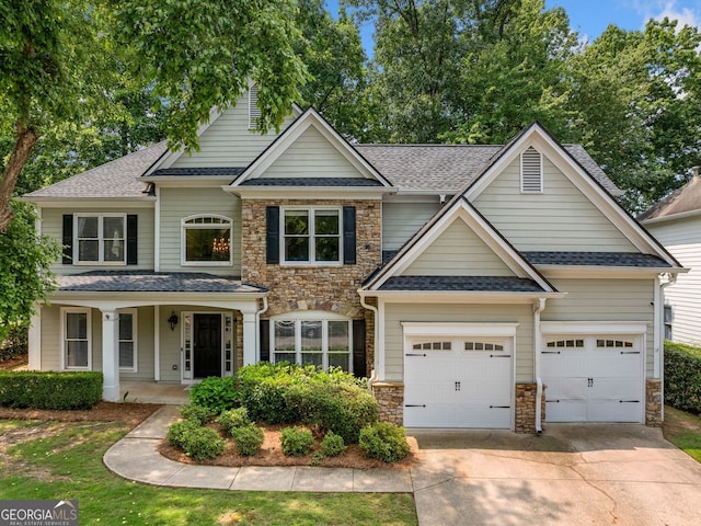 1205 Compass Pointe Xing, Alpharetta, GA 30005 - view of front of house with stone siding, driveway, roof with shingles, and covered porch