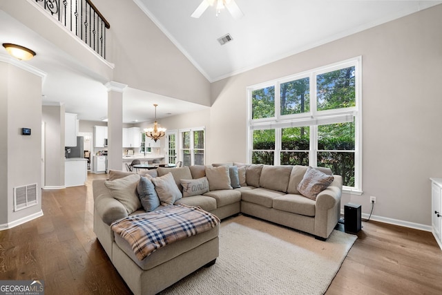 1205 Compass Pointe Xing, Alpharetta, GA 30005 - living room featuring high vaulted ceiling, a chandelier, wood finished floors, baseboards, and a ceiling fan