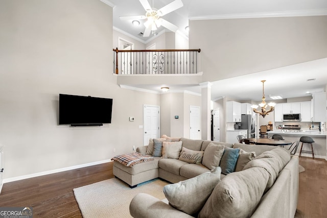 1205 Compass Pointe Xing, Alpharetta, GA 30005 - living room featuring a chandelier, wood finished floors, ceiling fan, baseboards, and ornamental molding
