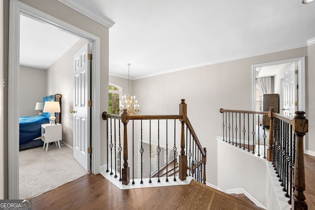 1205 Compass Pointe Xing, Alpharetta, GA 30005 - hallway featuring an upstairs landing, wood finished floors, a chandelier, baseboards, and ornamental molding