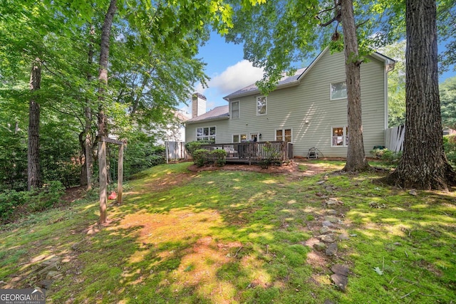 1205 Compass Pointe Xing, Alpharetta, GA 30005 - rear view of property featuring a wooden deck, a chimney, and a lawn