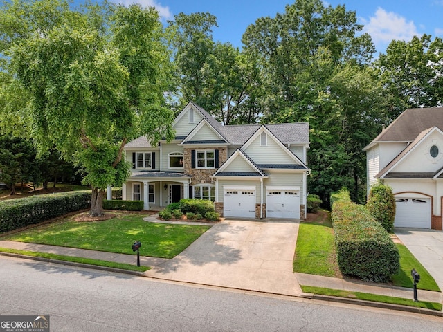 1205 Compass Pointe Xing, Alpharetta, GA 30005 - view of front of house with concrete driveway, a front lawn, a garage, and stone siding