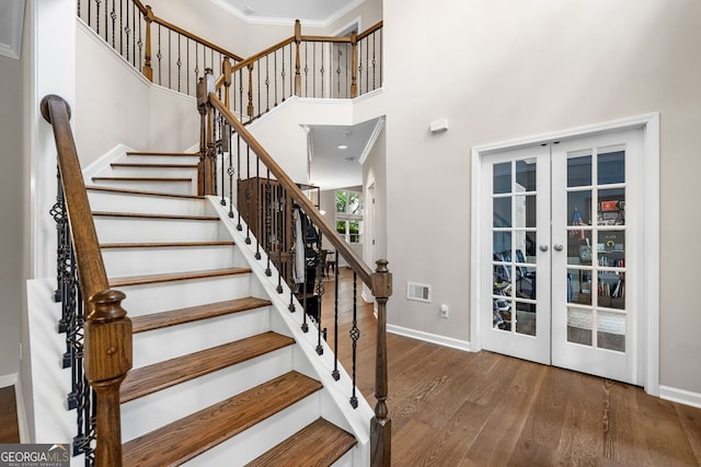 1205 Compass Pointe Xing, Alpharetta, GA 30005 - staircase with french doors, wood finished floors, baseboards, a high ceiling, and ornamental molding