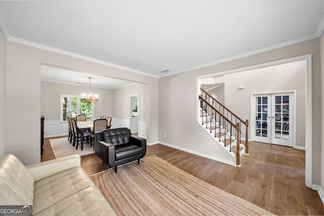 1205 Compass Pointe Xing, Alpharetta, GA 30005 - living area with a chandelier, wood finished floors, stairway, french doors, and ornamental molding