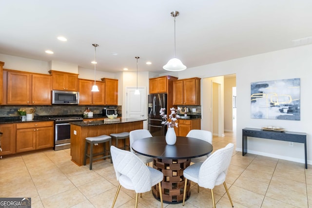 441 Spring View Dr, Woodstock, GA 30188 - kitchen with appliances with stainless steel finishes, brown cabinets, backsplash, a center island, and recessed lighting