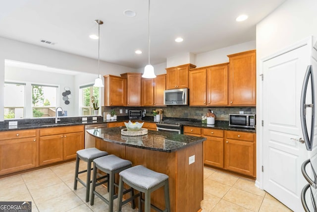 441 Spring View Dr, Woodstock, GA 30188 - kitchen featuring stainless steel appliances, a sink, brown cabinets, and recessed lighting