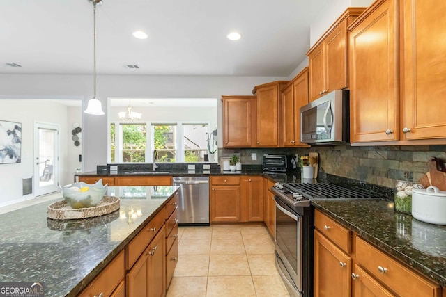 441 Spring View Dr, Woodstock, GA 30188 - kitchen featuring stainless steel appliances, a sink, brown cabinets, tasteful backsplash, and a chandelier