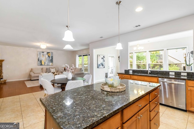 441 Spring View Dr, Woodstock, GA 30188 - kitchen featuring stainless steel dishwasher, a sink, light tile patterned floors, open floor plan, and a kitchen island