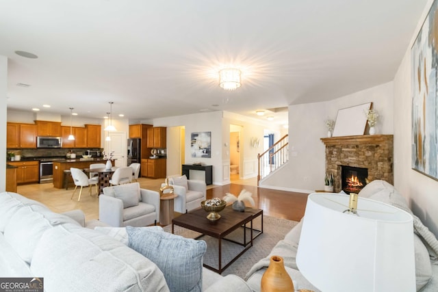 441 Spring View Dr, Woodstock, GA 30188 - living area featuring a fireplace, stairs, baseboards, and recessed lighting