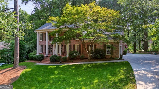 11940 Mountain Laurel Dr, Roswell, GA 30075 - neoclassical home featuring a front lawn, brick siding, and concrete driveway