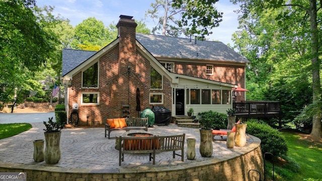 11940 Mountain Laurel Dr, Roswell, GA 30075 - back of house featuring a patio area, brick siding, a chimney, and a wooden deck