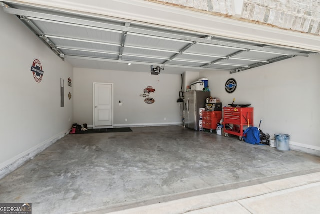 836 Hawkins Creek Dr, Jefferson, GA 30549 - garage with a garage door opener and stainless steel fridge