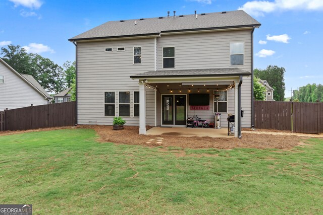 836 Hawkins Creek Dr, Jefferson, GA 30549 - back of property featuring a patio area, a fenced backyard, and a shingled roof