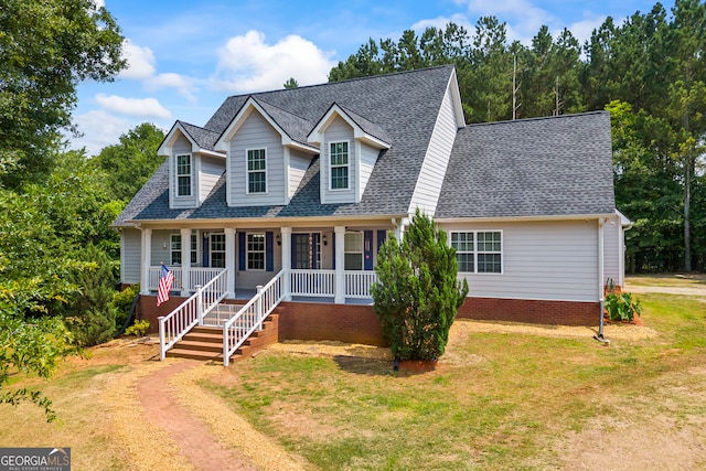 136 Wedgewood Dr, Danielsville, GA 30633 - new england style home featuring a shingled roof, a porch, and a front lawn