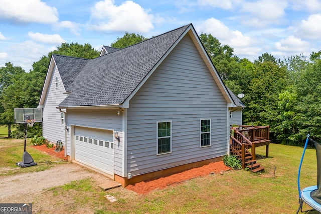 136 Wedgewood Dr, Danielsville, GA 30633 - view of side of property with a trampoline, roof with shingles, driveway, a yard, and a wooden deck