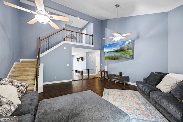 136 Wedgewood Dr, Danielsville, GA 30633 - living room with a ceiling fan, wood finished floors, stairs, a skylight, and a high ceiling