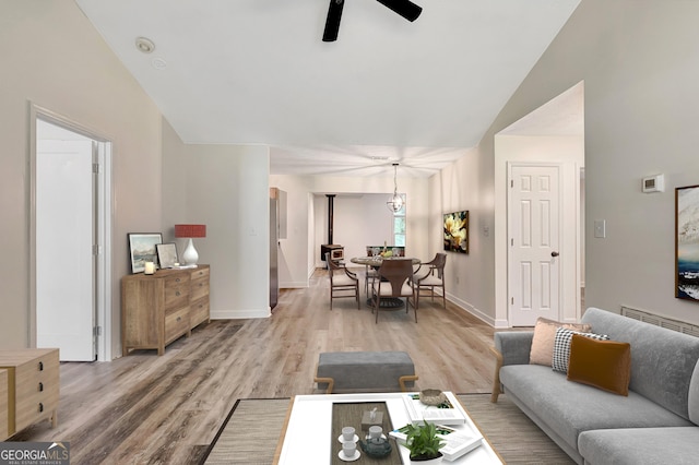 85 Prestigious Pl, Senoia, GA 30276 - living area with a ceiling fan, vaulted ceiling, light wood-style floors, and baseboards
