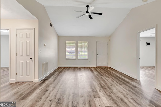 85 Prestigious Pl, Senoia, GA 30276 - unfurnished living room featuring vaulted ceiling, a ceiling fan, wood finished floors, and baseboards