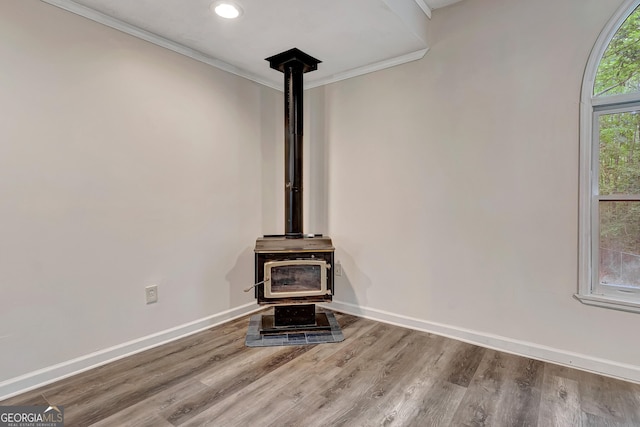 85 Prestigious Pl, Senoia, GA 30276 - detailed view of a wood stove, ornamental molding, baseboards, wood finished floors, and recessed lighting