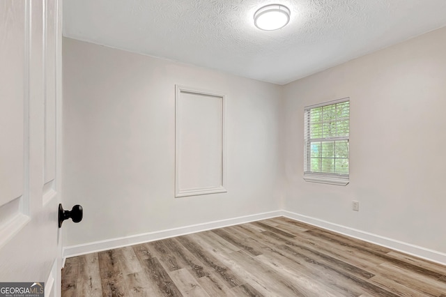85 Prestigious Pl, Senoia, GA 30276 - empty room featuring wood finished floors, a textured ceiling, and baseboards