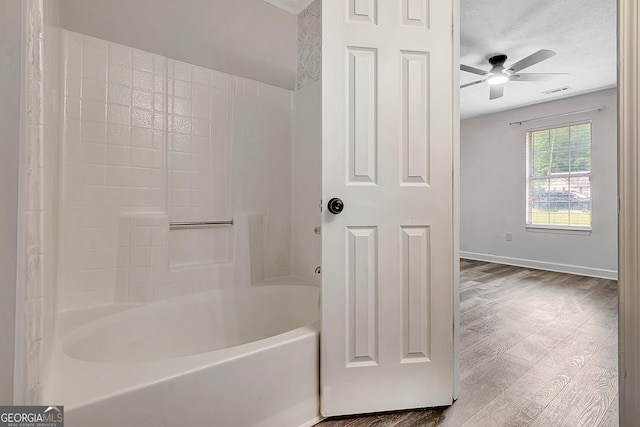 85 Prestigious Pl, Senoia, GA 30276 - bathroom with wood finished floors, a ceiling fan, baseboards, and shower / bathtub combination