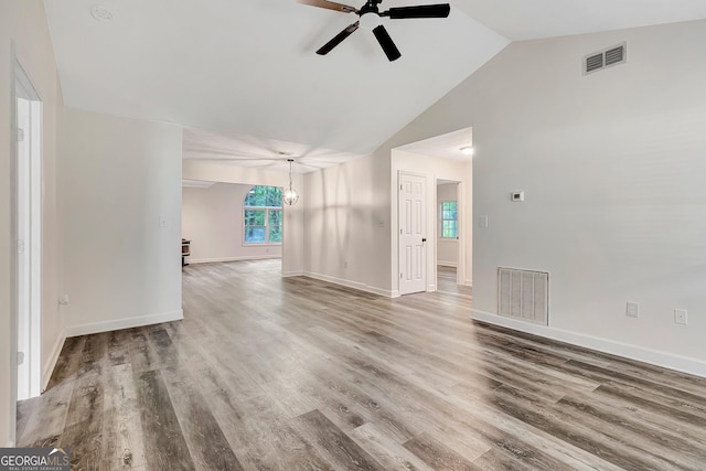 85 Prestigious Pl, Senoia, GA 30276 - spare room with a ceiling fan, a chandelier, wood finished floors, baseboards, and high vaulted ceiling