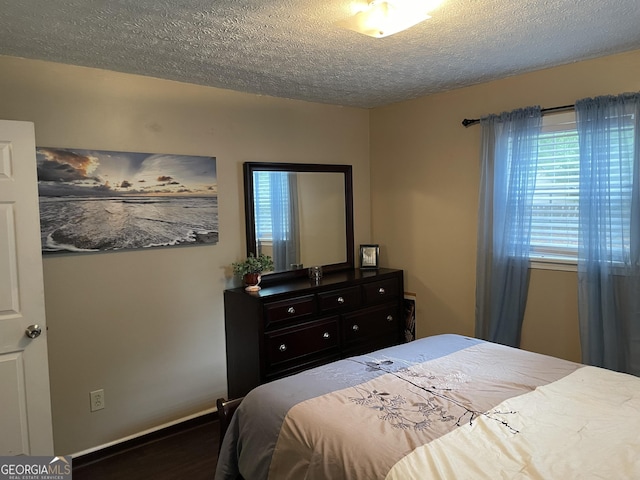 501 Lakeshore Dr, Monticello, GA 31064 - bedroom with wood finished floors, a textured ceiling, and baseboards