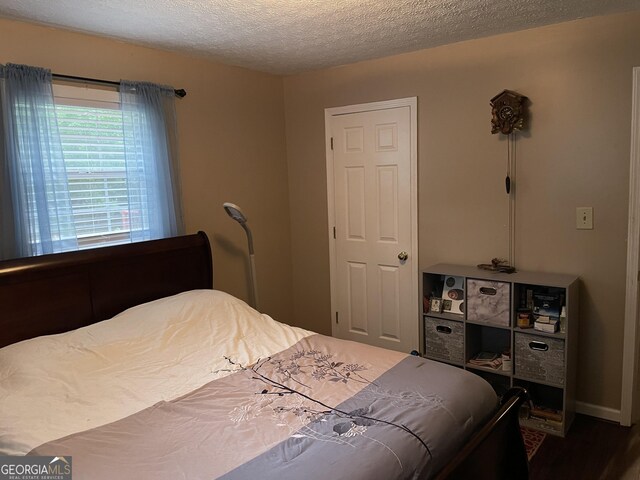 501 Lakeshore Dr, Monticello, GA 31064 - bedroom featuring a textured ceiling and wood finished floors